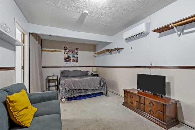 carpeted bedroom with a textured ceiling and a wall mounted AC