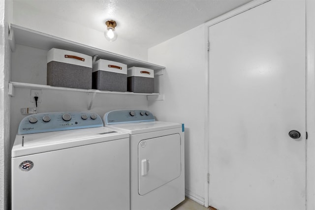 clothes washing area featuring washer and clothes dryer