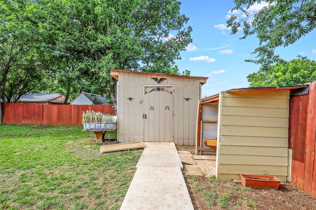 view of outbuilding with a yard