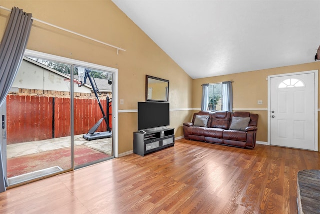 living room featuring lofted ceiling and hardwood / wood-style floors