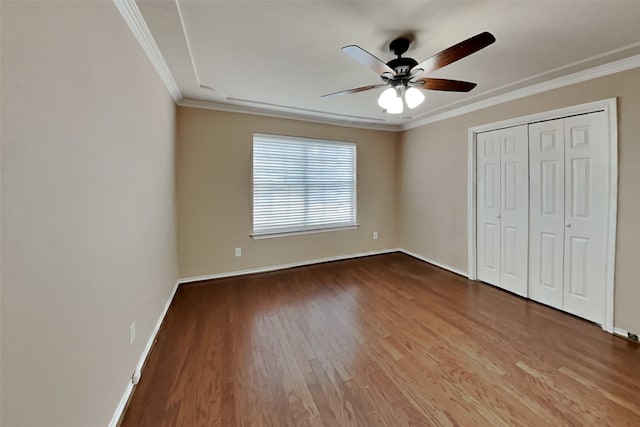 unfurnished bedroom with hardwood / wood-style floors, ceiling fan, and crown molding