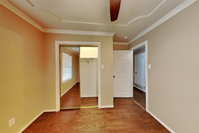 unfurnished bedroom featuring crown molding, a closet, ceiling fan, and hardwood / wood-style floors