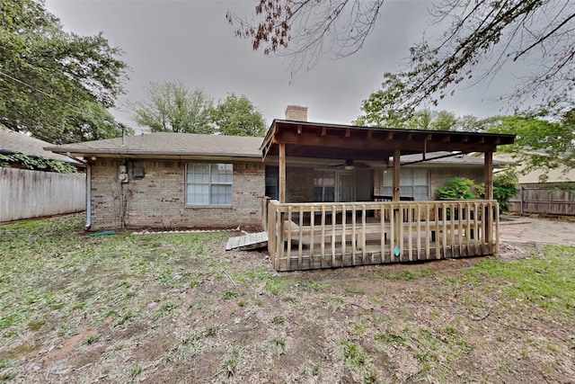 rear view of property with a deck and ceiling fan