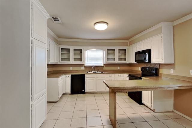 kitchen featuring crown molding, black appliances, light tile floors, sink, and white cabinetry