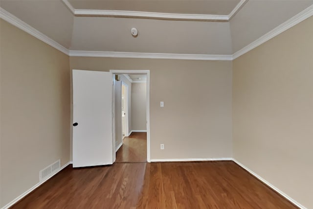 spare room with ornamental molding, lofted ceiling, and wood-type flooring