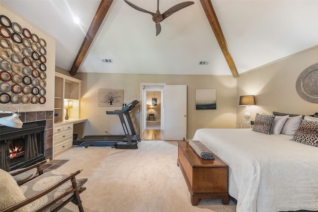 bedroom featuring light colored carpet, ceiling fan, high vaulted ceiling, beamed ceiling, and a tiled fireplace