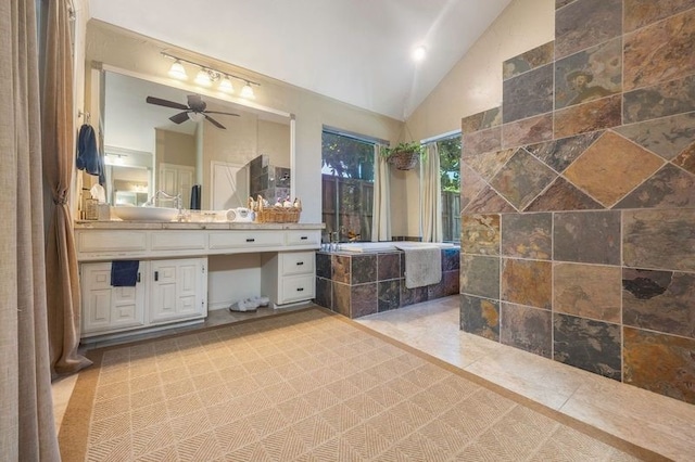 bathroom featuring vanity, vaulted ceiling, a bathtub, and ceiling fan