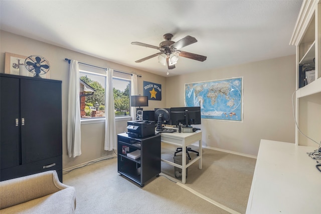 carpeted office featuring ceiling fan