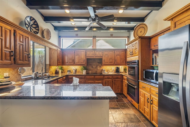 kitchen featuring kitchen peninsula, backsplash, stainless steel appliances, sink, and beam ceiling