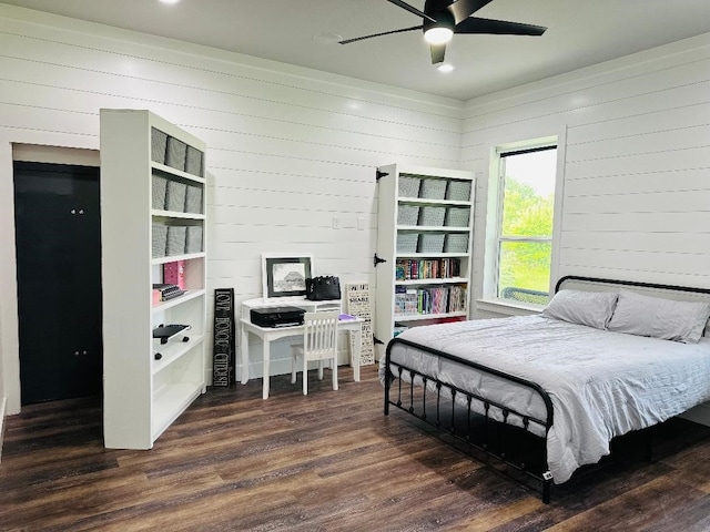 bedroom with dark hardwood / wood-style floors and ceiling fan