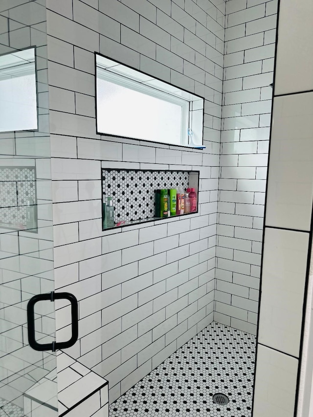 bathroom featuring a shower with shower door