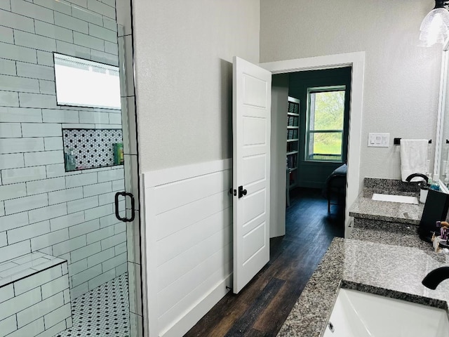 bathroom featuring vanity, a shower with shower door, and hardwood / wood-style floors