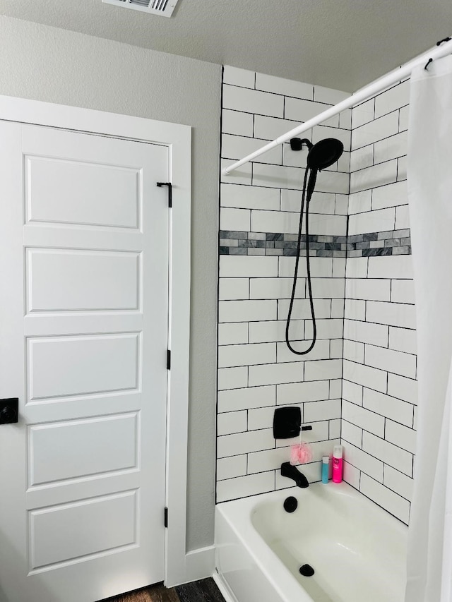 bathroom with shower / bathtub combination with curtain