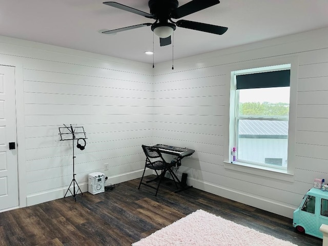 misc room with dark wood-type flooring and ceiling fan