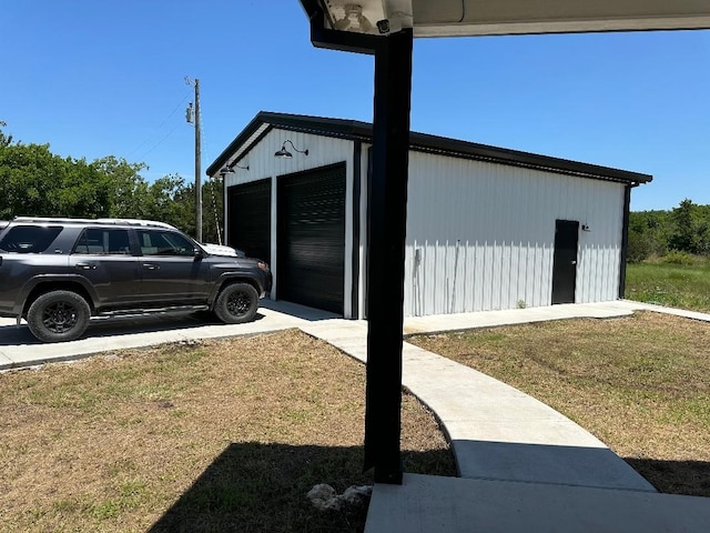 view of home's exterior with an outdoor structure and a lawn