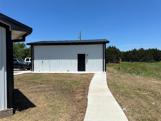 view of outbuilding with a yard