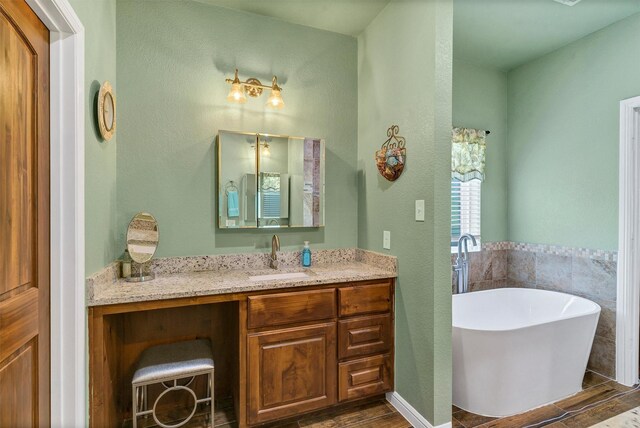 bathroom with a bath and vanity