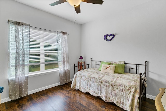 bedroom with dark hardwood / wood-style flooring and ceiling fan