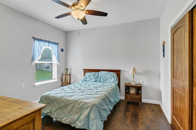 bedroom with ceiling fan, a closet, and dark wood-type flooring