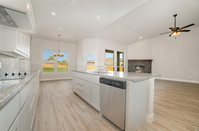 kitchen featuring white cabinetry, backsplash, a wealth of natural light, and dishwasher