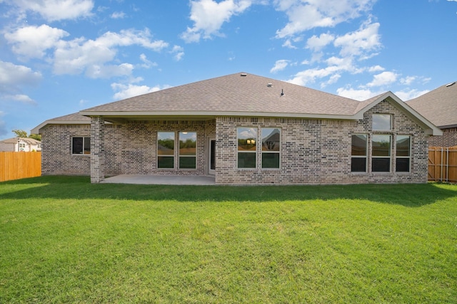 back of property with a lawn and a patio