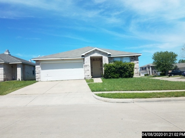 single story home featuring a garage and a front yard