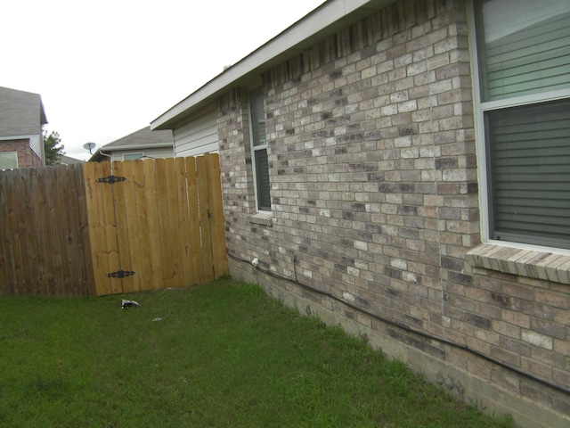 view of side of home featuring a lawn