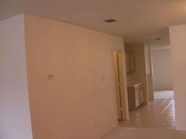 hallway with light tile patterned floors