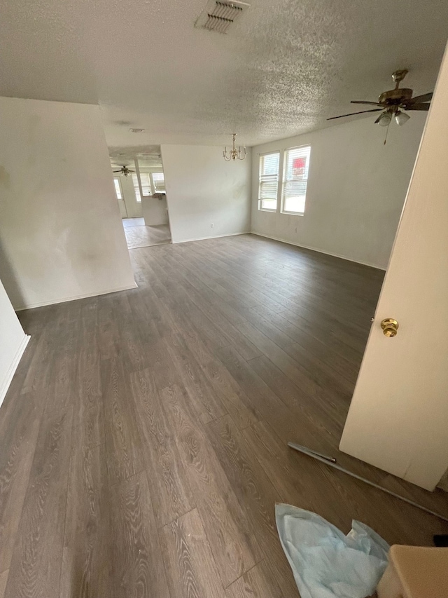 interior space featuring dark wood-type flooring, a textured ceiling, and ceiling fan