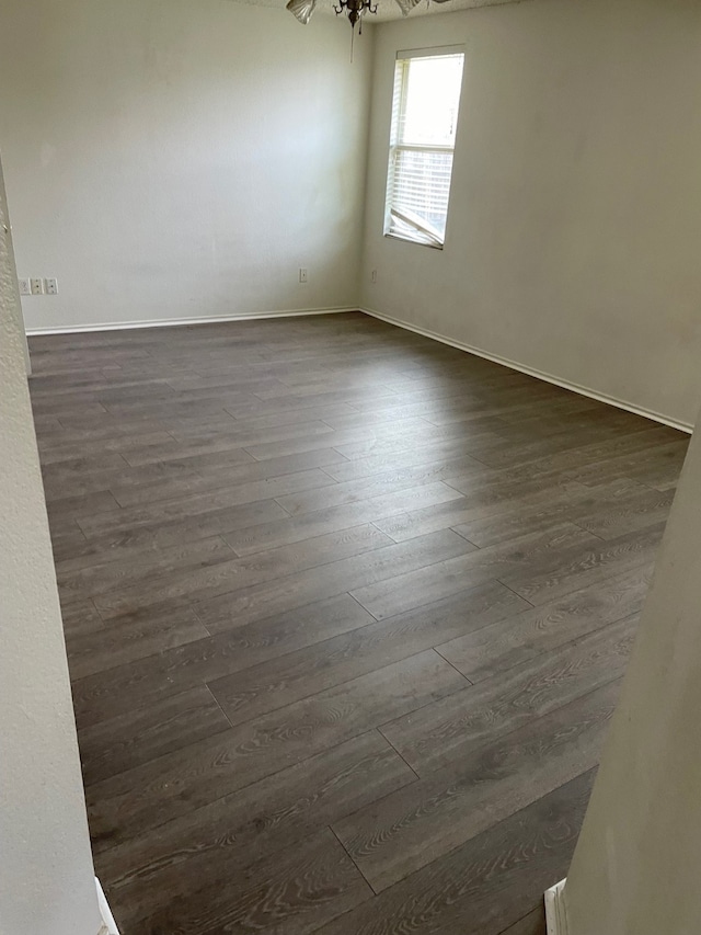 empty room with dark hardwood / wood-style flooring