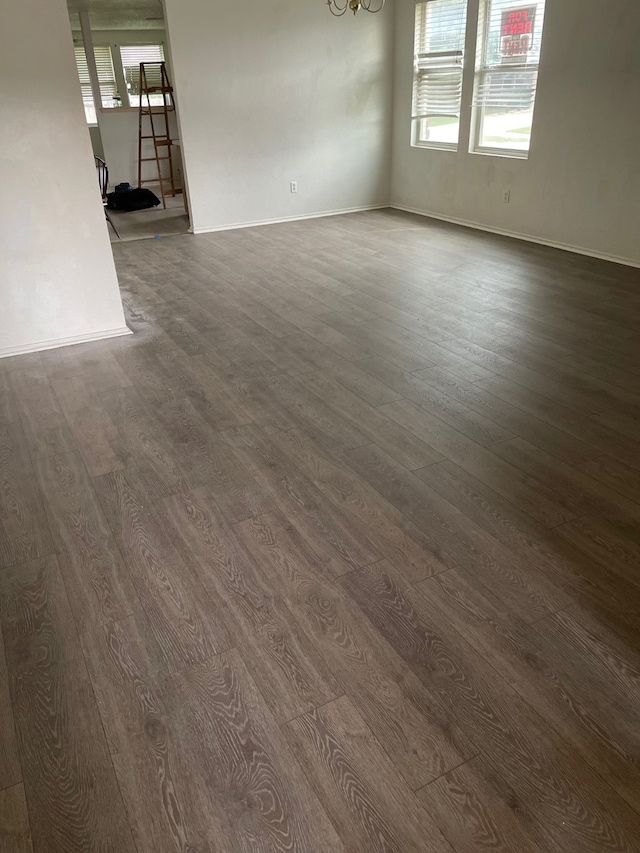 spare room featuring dark wood-type flooring