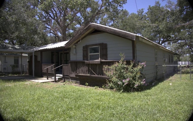 view of side of home featuring a lawn