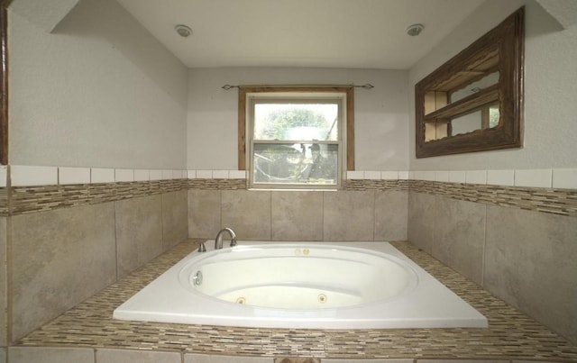 bathroom featuring tiled tub