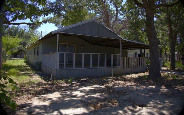 view of side of property with a sunroom