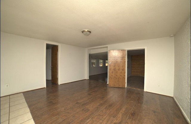 spare room with dark wood-type flooring