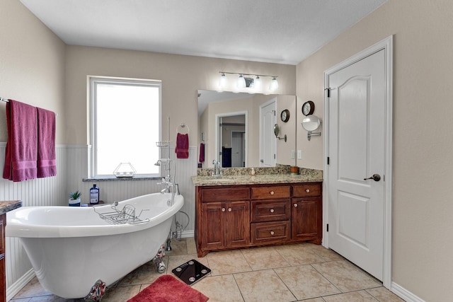 bathroom featuring tile patterned floors, vanity, and a bath