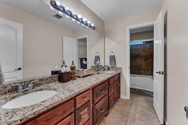 bathroom featuring vanity and tiled shower / bath combo