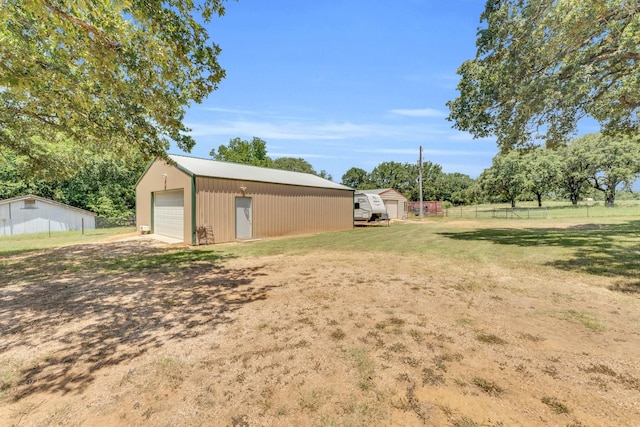 view of yard featuring an outbuilding and a garage