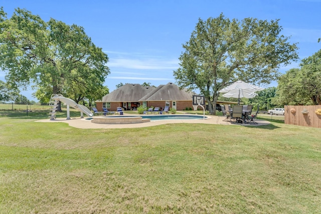 view of yard with a patio and a fenced in pool