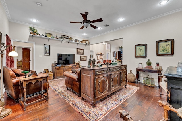 living room with hardwood / wood-style flooring, ceiling fan, and ornamental molding