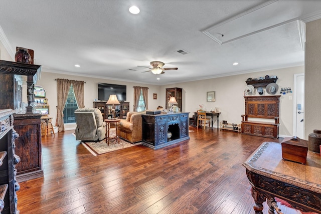 living room featuring wood-type flooring, a textured ceiling, ceiling fan, and crown molding