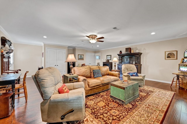 living room featuring dark hardwood / wood-style floors, ceiling fan, and ornamental molding