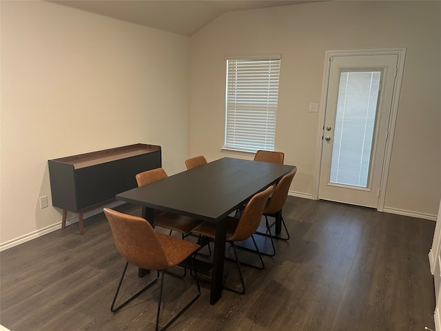 dining room featuring lofted ceiling and dark hardwood / wood-style floors