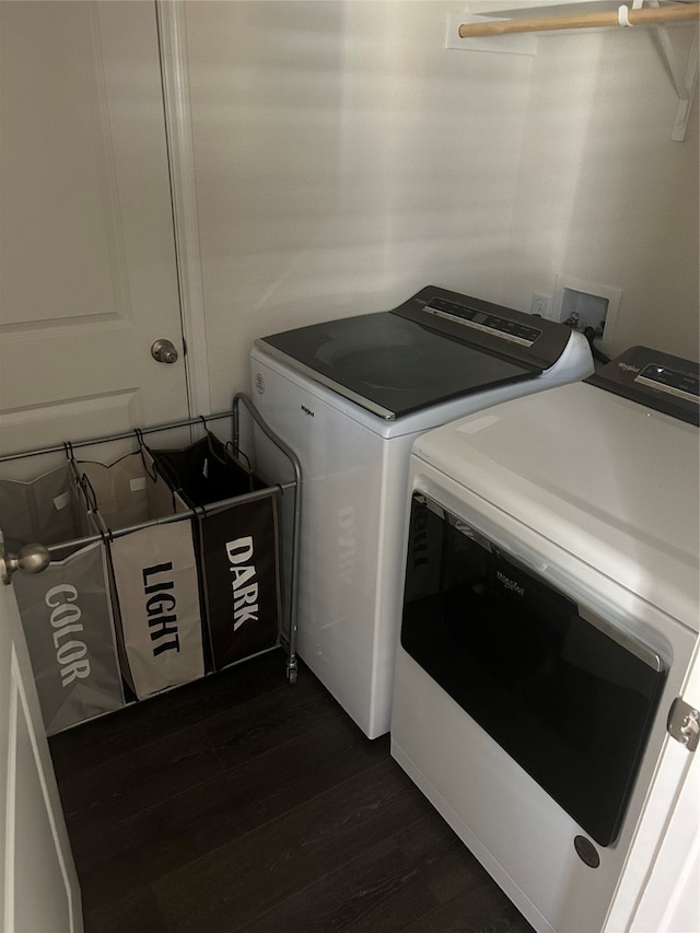 clothes washing area featuring independent washer and dryer and dark hardwood / wood-style flooring