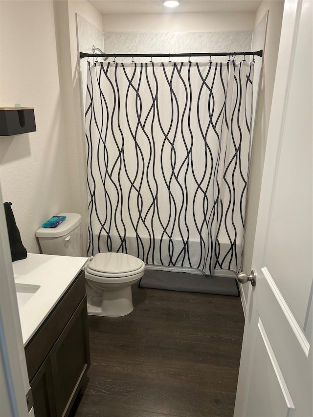 full bathroom with toilet, shower / tub combo with curtain, vanity, and wood-type flooring