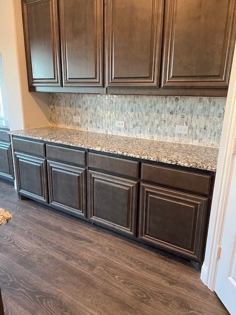 interior space featuring wood-type flooring and tasteful backsplash