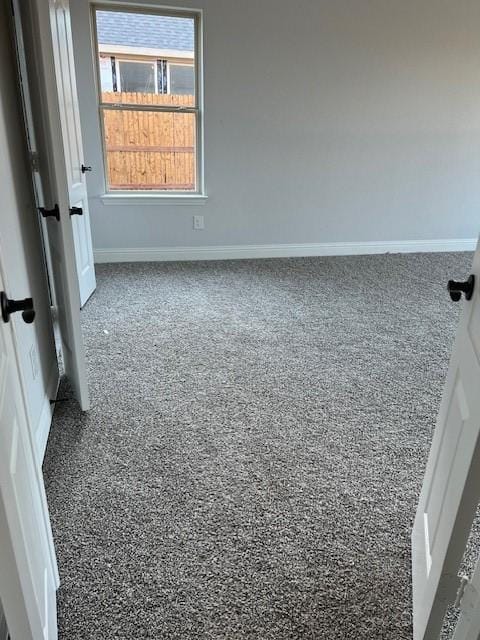 unfurnished room featuring carpet flooring