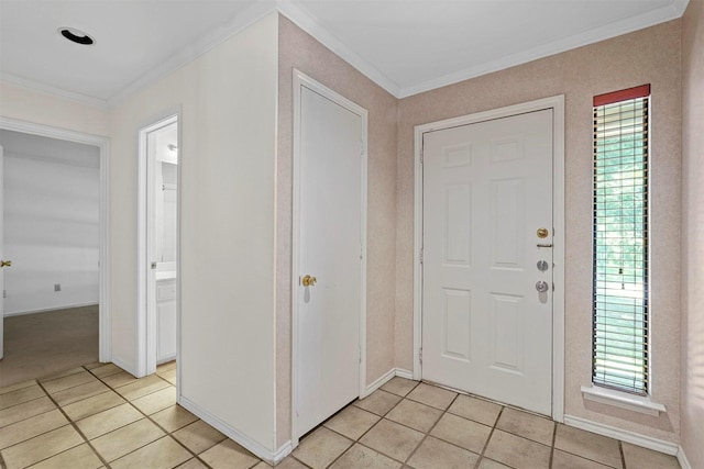 tiled foyer entrance with a healthy amount of sunlight and crown molding