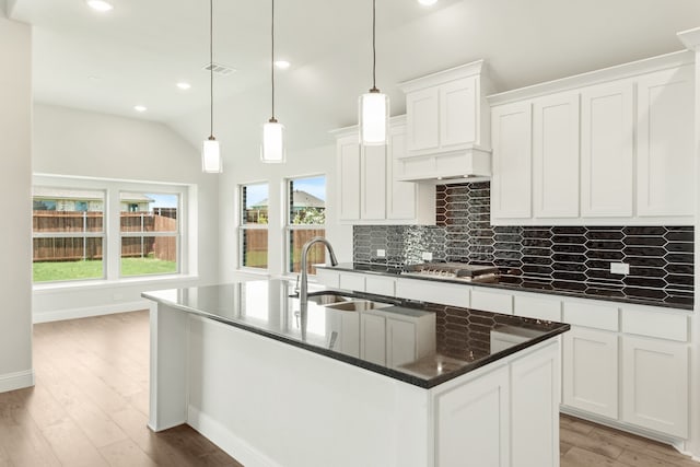 kitchen featuring white cabinetry, sink, decorative backsplash, and light hardwood / wood-style floors