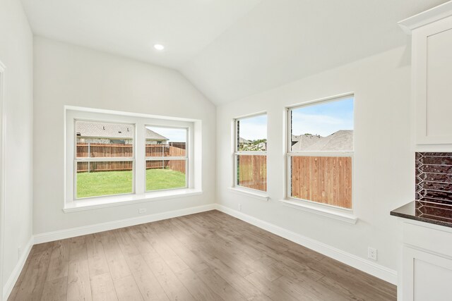 interior space with lofted ceiling and light hardwood / wood-style floors